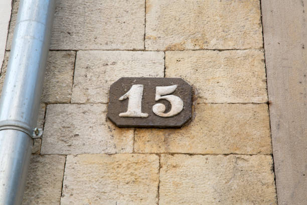 istock Number Fifteen on Stone Wall 1170292848