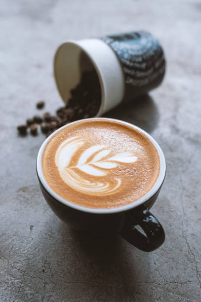 istock hot latte art and coffee bean on black table with soft-focus and over light in the background 1170292866