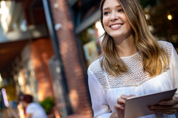 istock Beautiful brunette girl using tablet for work, freelance, blogging, studying, shopping 1170293359