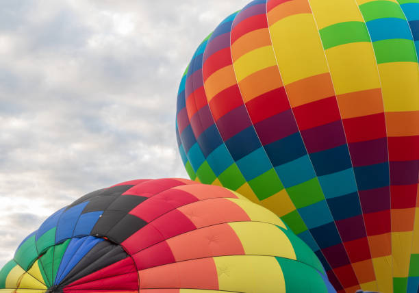 istock Two multi-colored hot air balloons getting inflated 1170294420