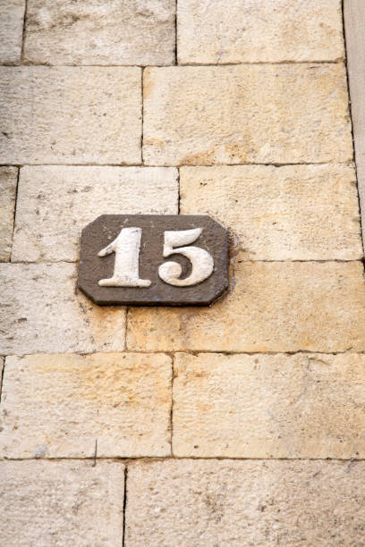 istock Number Fifteen on Stone Wall 1170294586