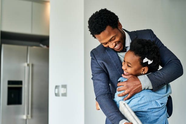 A hug from my daughter is priceless Cropped shot of a young girl hugging her father after work photos stock pictures, royalty-free photos & images