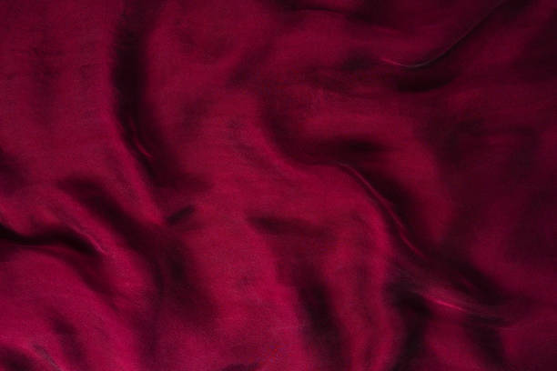 istock Soft smooth burgundy silk fabric background. Fabric texture. 1170295028