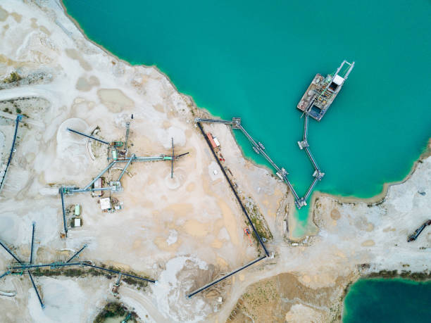 Sand mining from the lake and extraction process - open pit mine extracting sand and gravel Sand mining in the lake and extraction process sand mine stock pictures, royalty-free photos & images