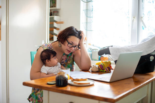 istock Worried mother paying bills online 1170295084