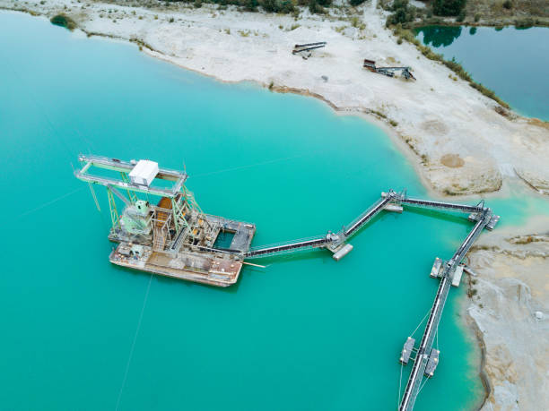 istock Sand mining from the lake and extraction process - open pit mine extracting sand and gravel 1170295468