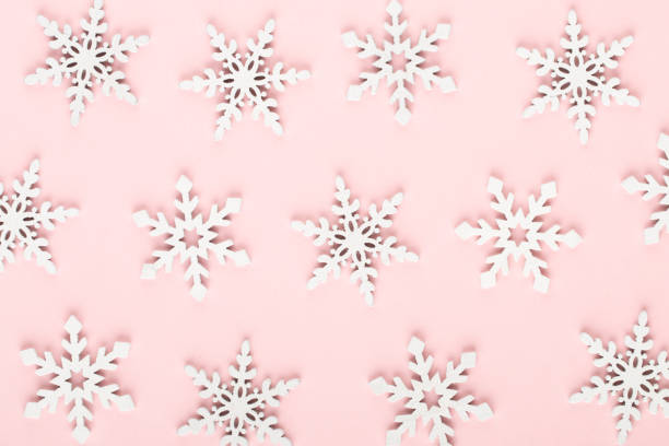 istock Christmas background. White snow decorations on a pink background. 1170296046