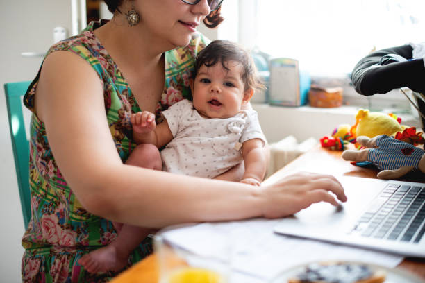 istock Smiling baby in mothers lap 1170296122