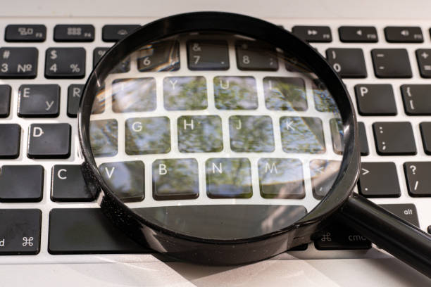 istock a magnifying glass on the keyboard, searching on the internet concept 1170296295
