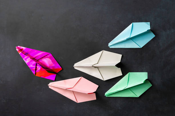 istock a unique paper plane with some regular ones, leadership concept on the table 1170296563