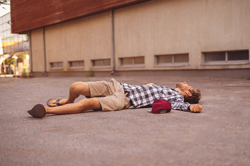 man on the ground, got injury outdoors, fall down