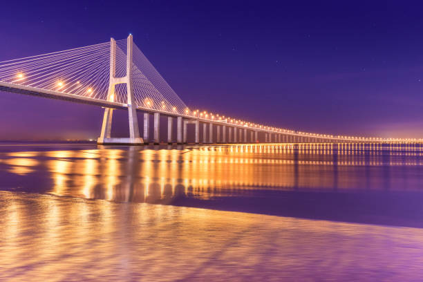 istock View of a modern cable-stayed bridge at night (Vasco da Gama Bridge), Lisbon, Portugal 1170297073