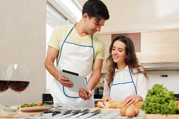 istock Cooking couple discussing recipe 1170297835