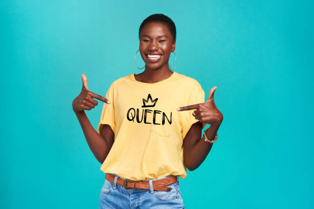 The name says it all Studio shot of a confident young woman wearing a t shirt with “queen” on it against a turquoise background queen royal person photos stock pictures, royalty-free photos & images