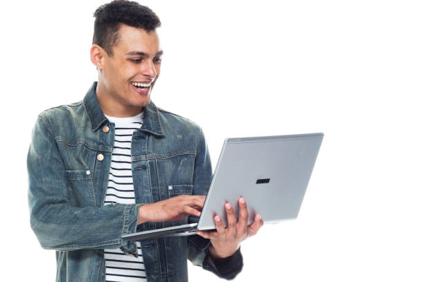 istock Good looking tall black man wearing denim jacket - using a laptop 1170298957