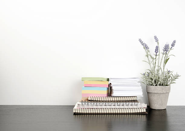istock a stack of spiral notebooks and colored stickers, next to a ceramic pot 1170300919