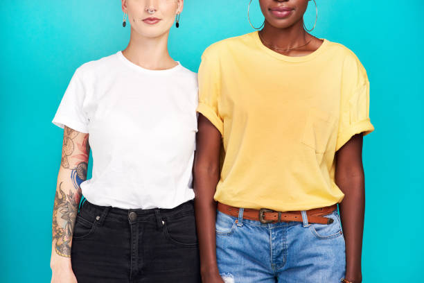 Blank for your branding Cropped studio shot of two young women standing together against a turquoise background blank t shirt stock pictures, royalty-free photos & images