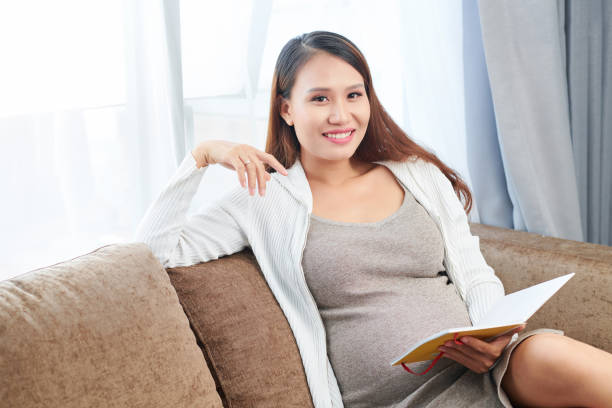 istock Pregnant woman checking gratitude journal 1170301855