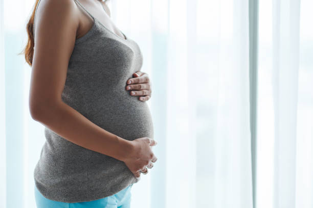 istock Woman touching her baby bump 1170302015