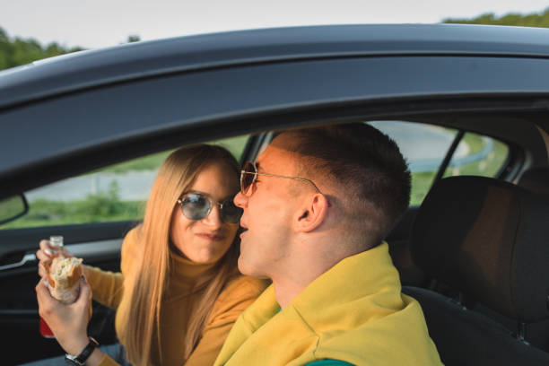 istock Happy couple having fun in car during road trip 1170303989