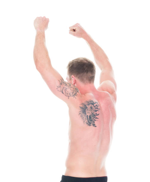 istock Handsome shirtless man with hands up cheering, rear view 1170304026