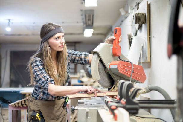 istock blonde girl working in carpenter's workshop 1170304206