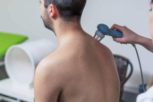 istock Physiotherapist treating patient with electrical stimulation. 1170304385