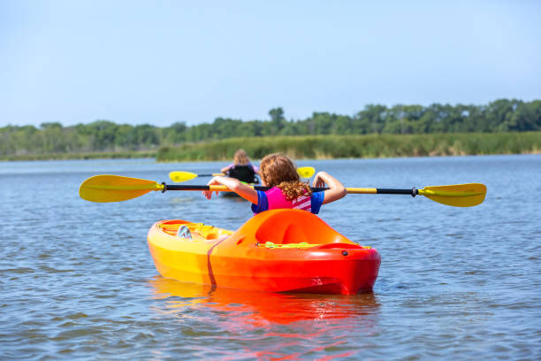 istock Two Girls Kayaking on Lake in Summer 1170305199
