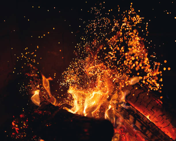 istock burning fire logs with sparks in the fireplace 1170305509