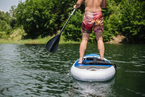 istock Unrecognizable man with a paddleboard at a lake 1170307073