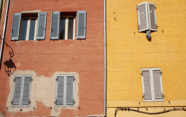 Two buildings together with beautiful colors and shutters