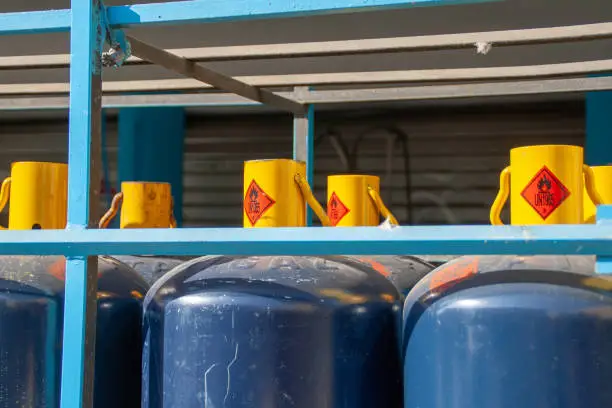 Several blue propane tanks in a structure