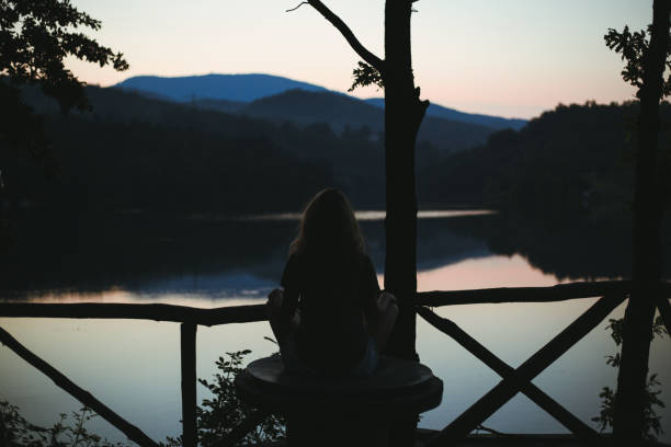 istock Girl enjoying sunset at a lake 1170307968