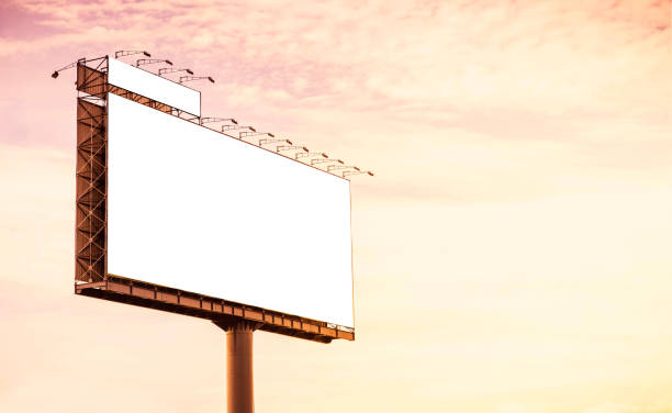 istock Blank billboard mockup with white screen at sunset background. Copy space banner for advertisement. Outdoor Frame template poster media Ads display. 1170308391