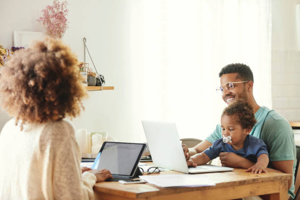 istock Parents working while sitting with son at home 1170309523