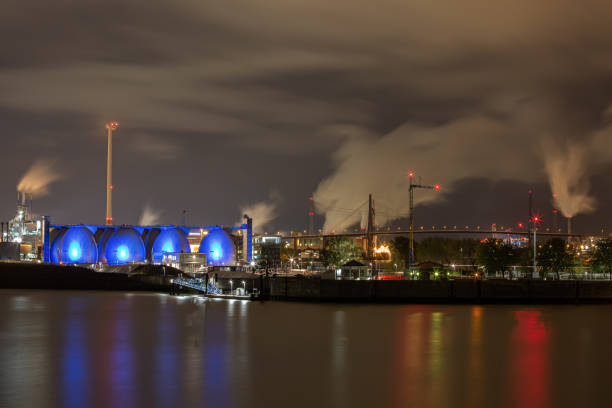 Port of Hamburg at night Port of Hamburg with Köhlbrand bridge and industry at night long exposure industry factory hamburg germany stock pictures, royalty-free photos & images