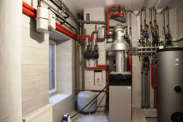 Photo of Autonomous heating system in the boiler room. boiler, water heater, expansion tank and other pipes