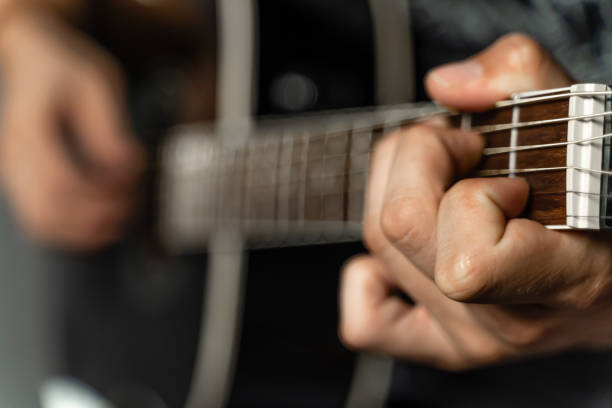 istock Close up of black guitar fretboard 1170310031