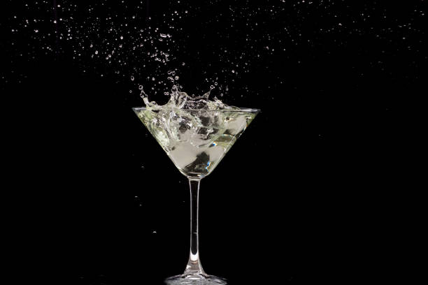 istock a glass of martini and a splash from falling olives or ice 1170310884