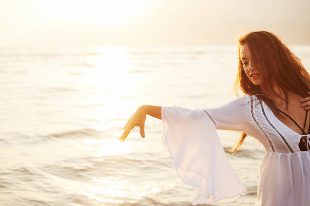 istock A young woman is dancing at summer beach 1170310906