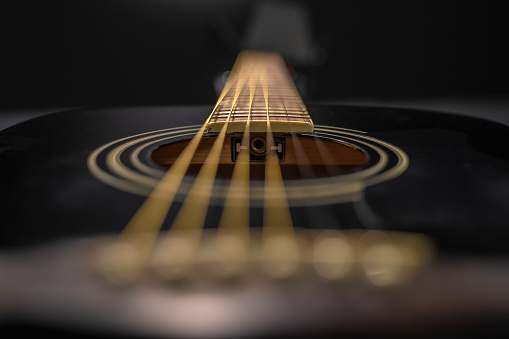 Guitar neck with metal string, macro shot with soft focus.