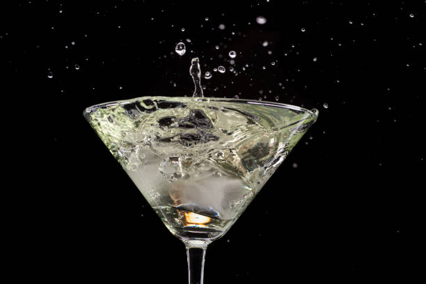 istock a glass of martini and a splash from falling olives or ice 1170311237