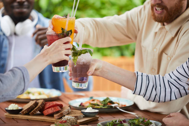 Young people toasting with cocktails