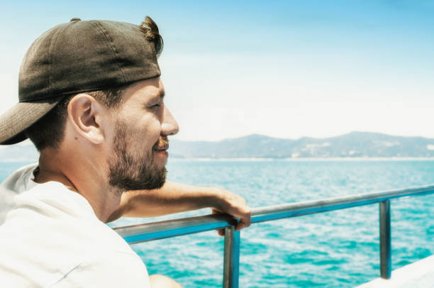 istock Young man enjoying a sea voyage 1170312614