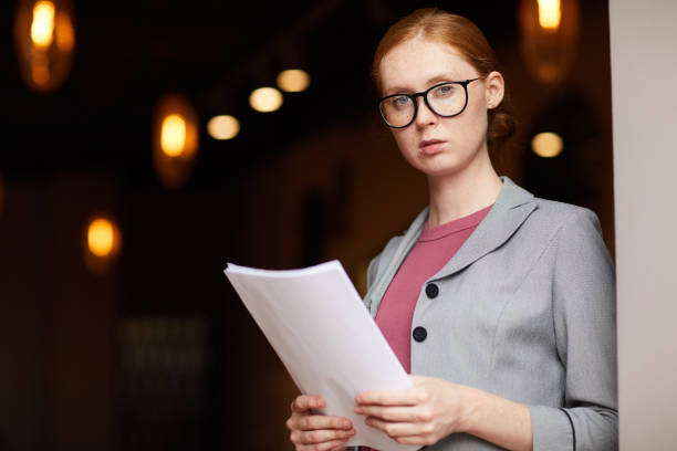 istock Serious businesswoman with document 1170313651