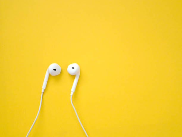 istock White earphones on yellow background 1170320948
