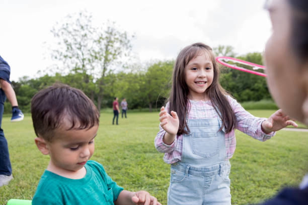 istock Children enjoy playing bubbles at family picnic 1170329425
