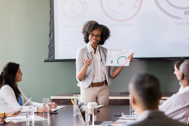 istock Cheerful businesswoman explains financial data 1170329677
