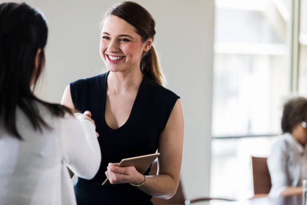 istock Businesswomen greeting one another 1170329699