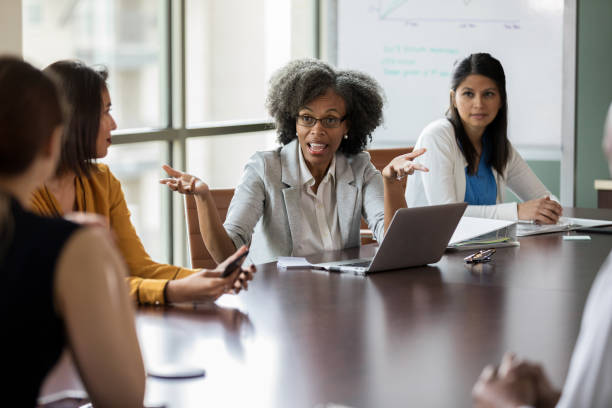 istock Concerned businesswoman talks with colleagues 1170329709